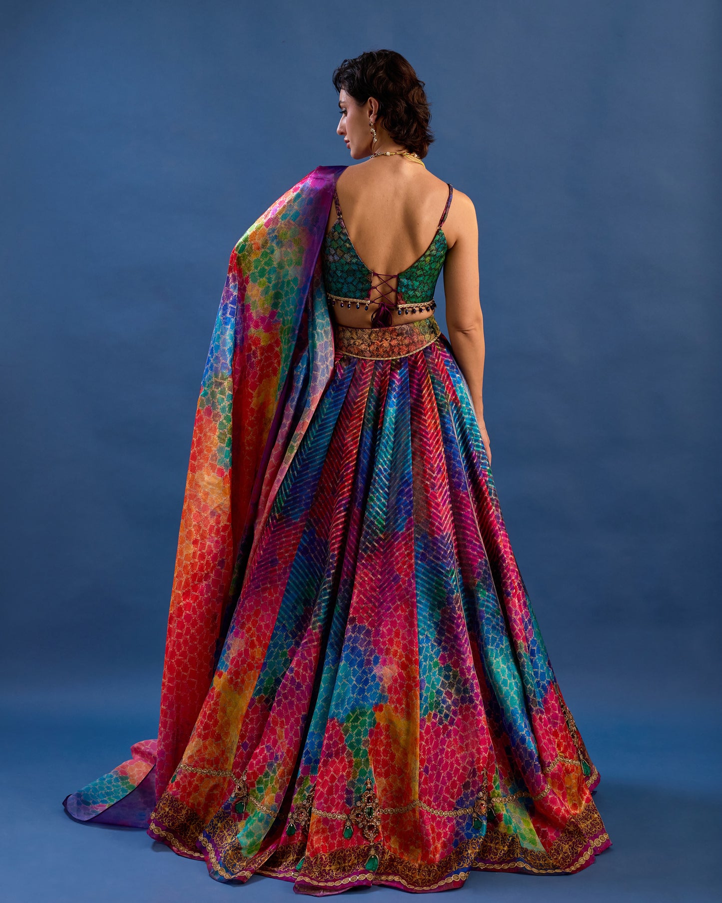 Woman wearing a colorful dress with a blue background