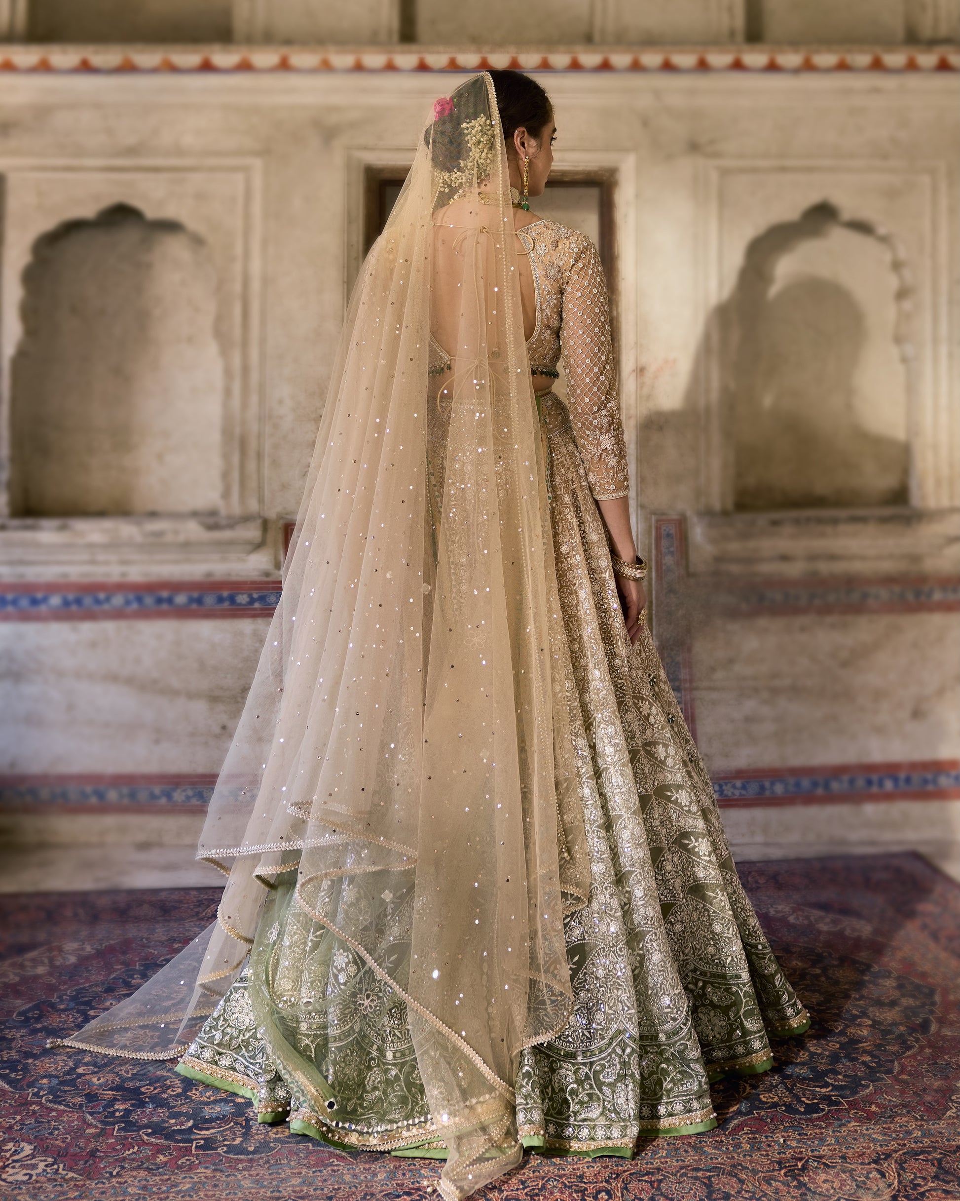 Flat lay of three-piece Nighat lehenga set including blouse, skirt, and dupatta