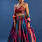 Woman wearing a colorful traditional outfit against a blue background